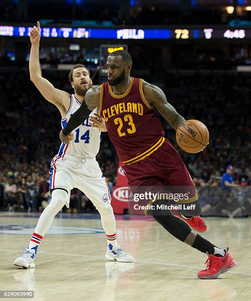 LeBron James of the Cleveland Cavaliers dribbles the ball against Sergio Rodriguez of the Philadelphia 76ers at Wells Fargo Center on November 27,...