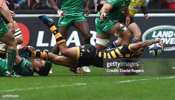 Kurtley Beale of Wasps dives over for the first try on his Wasps's debut during the European Champions Cup match between Wasps and Connacht at the...
