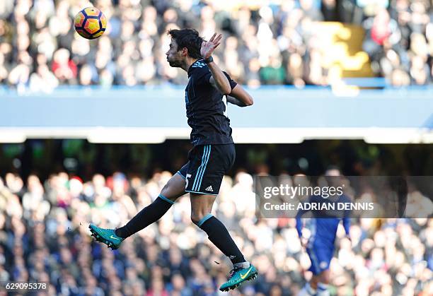 West Bromwich Albion's Argentinian midfielder Claudio Yacob heads the ball during the English Premier League football match between Chelsea and West...