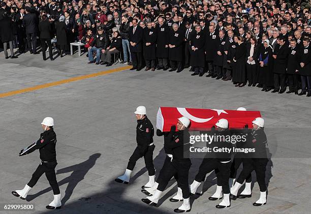 Turkish police officers carry the flag-draped coffins of police officers killed in yesterday's blast on December 11, 2016 in Istanbul, Turkey....