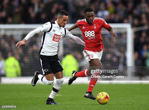 Tom Ince of Derby County and Mustapha Carayol of Nottingham Forest battle for the ball during the Sky Bet Championship match between Derby County and...