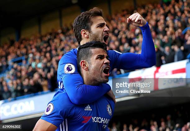 Diego Costa of Chelsea celebrates scoring the opening goal with his team mate Cesc Fabregas during the Premier League match between Chelsea and West...