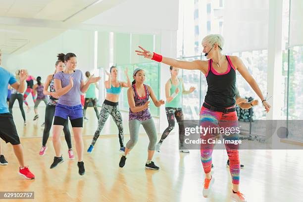 fitness instructor leading aerobics class - boss over shoulder stock pictures, royalty-free photos & images