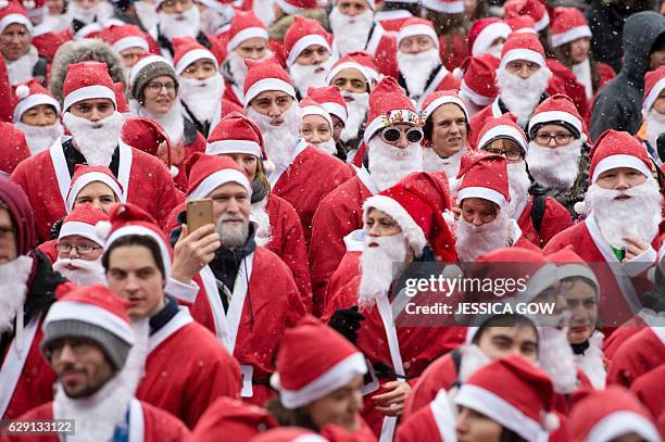 Around 1500 people in Santa Claus costumes warm up in the Kungstradgarden Park prior to the 3 kilometer long Santa Run in Stockholm, Sweden, December...
