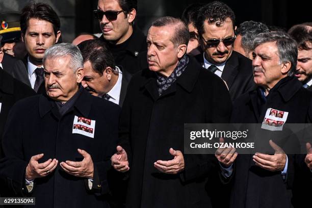 Turkish President Recep Tayyip Erdogan , Turkish Prime Minister Binali Yildirim and former Turkish president Abdullah Gul , pray as they attend a...