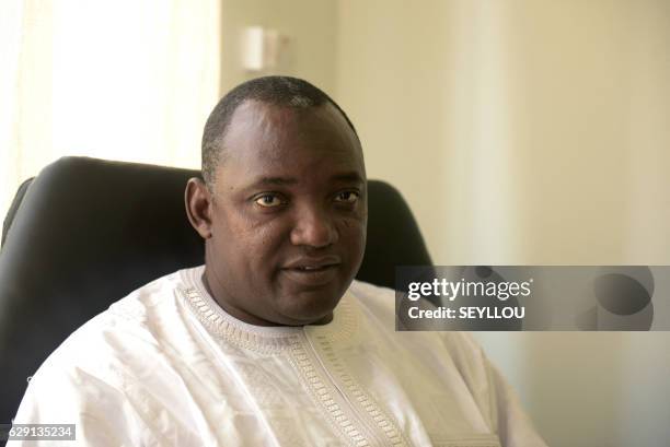 Gambia's President-elect Adama Barrow poses in his office in Serekunda, on December 11, 2016. Gambia's incumbent head of state Yahya Jammeh will...