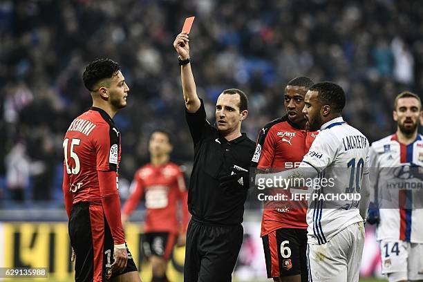 Rennes'Algeria defender Ramy Bensebaini receives a red card from French referee Benoit Millot during the French L1 football match Olympique Lyonnais...