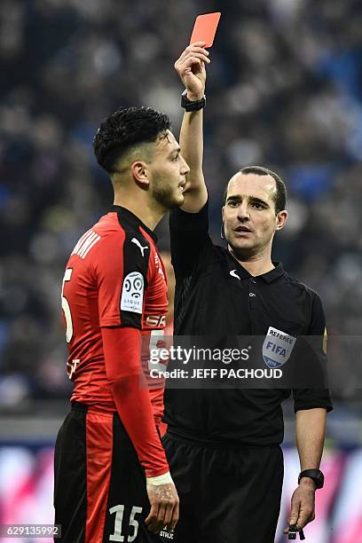 Rennes'Algeria defender Ramy Bensebaini receives a red card from French referee Benoit Millot during the French L1 football match Olympique Lyonnais...