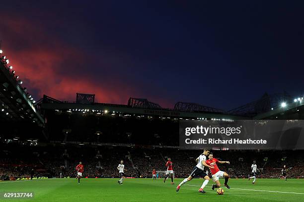 Harry Winks of Tottenham Hotspur and Matteo Darmian of Manchester United compete for the ball during the Premier League match between Manchester...