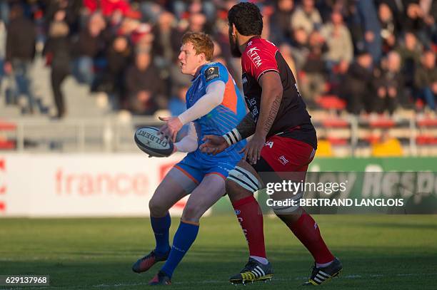 Toulon's French lock Romain Taofifenua attempts to tackle Llanelli's fly-half from Wales Rhys Patchell during the European Rugby Champions Cup match...