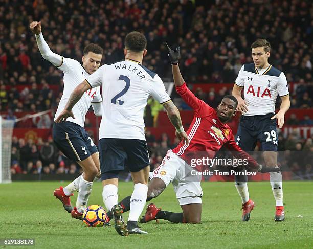 Paul Pogba of Manchester United in action with Dele Alli and Kyle Walker of Tottenham Hotspur during the Premier League match between Manchester...