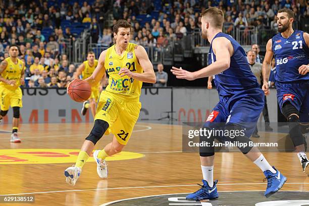 Dragan Milosavijevic of Alba Berlin, Evan Smotrycz and Harper Kamp of the Eisbaeren Bremerhaven during the game between Alba Berlin and Eisbaeren...