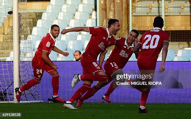 Sevilla's midfielder Vicente Iborra celebrates with teammates after scoring during the Spanish league football match RC Celta de Vigo vs Sevilla FC...