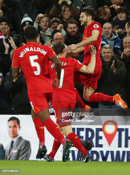 Adam Lallana of Liverpool celebrates scoring the opening goal with his team mates during the Premier League match between Liverpool and West Ham...