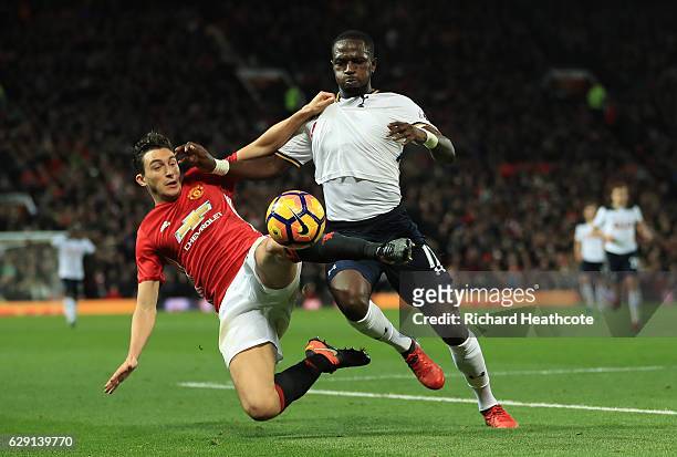 Moussa Sissoko of Tottenham Hotspur and Matteo Darmian of Manchester United compete for the ball during the Premier League match between Manchester...