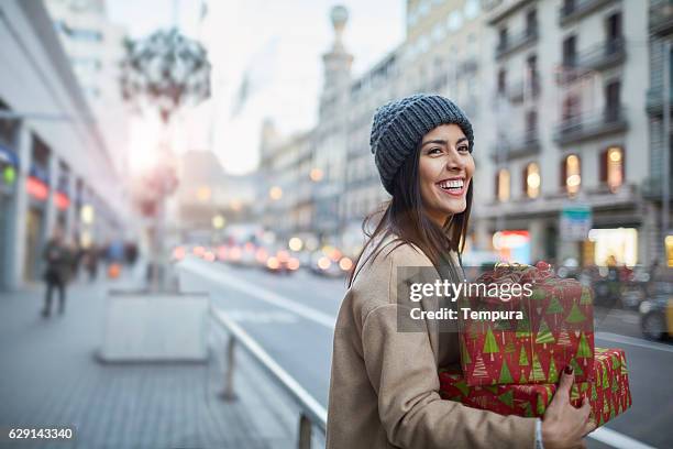 hialing a taxi after some christmas shopping. - cadeau noel stockfoto's en -beelden