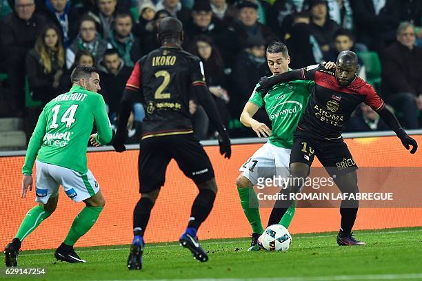 Guinguamps French forward Yannis Salibur vies with Saint-Etienne's French forward Romain Hamouma during the French L1 football match between...