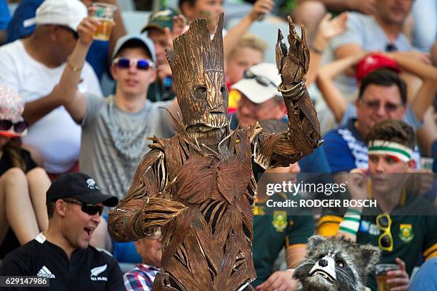 Two persons dressed as Groot and Rocket Raccoon from Guardians of the Galaxy react during the World Rugby Sevens Series semi-final match England vs...