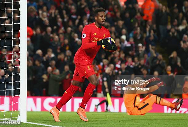 Darren Randolph of West Ham United looks dejected as Divock Origi of Liverpool celebrates as he scores their second goal during the Premier League...