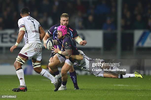 Jack Nowell of Exeter is tackled by Blair Connor of Bordeaux during the European Rugby Challenge Cup Pool 5 match between Exeter Chiefs and...