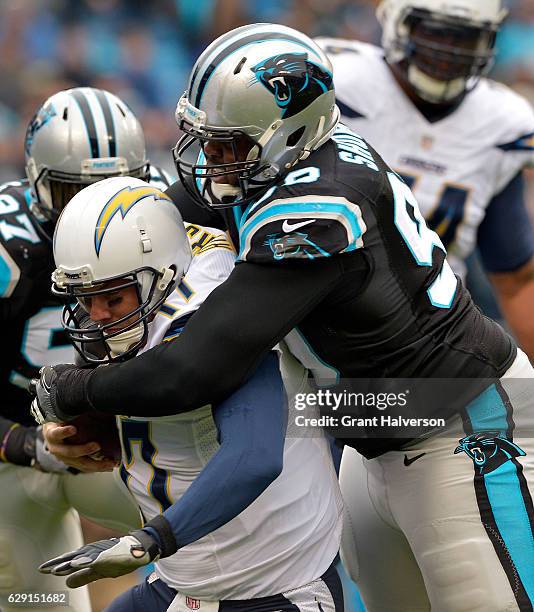 Kawann Short of the Carolina Panthers sacks Philip Rivers of the San Diego Chargers in the first quarter during the game at Bank of America Stadium...