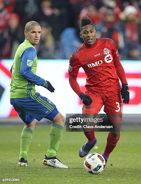 Armando Cooper of the Toronto FC plays the ball in front of Osvaldo Alonso of the Seattle Sounders during the 2016 MLS Cup at BMO Field on December...