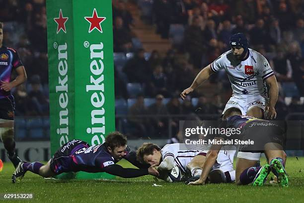 Baptiste Serin of Bordeaux scores his sides first try despite the challenge from Lachlan Turner of Exeter during the European Rugby Challenge Cup...