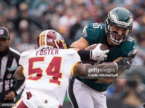 Zach Ertz of the Philadelphia Eagles runs with the ball against Mason Foster of the Washington Redskins in the first quarter at Lincoln Financial...