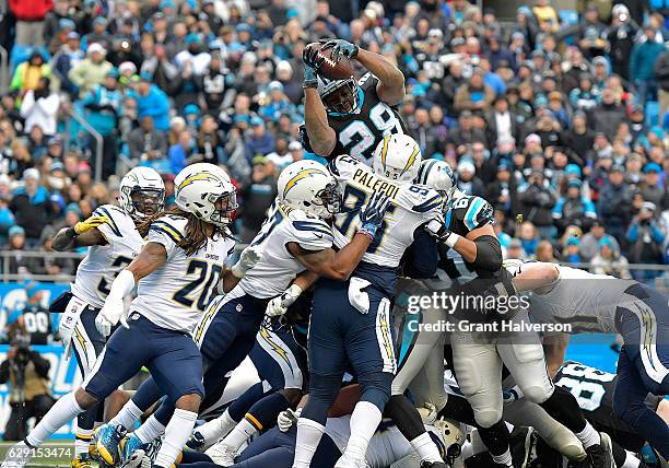 Jonathan Stewart of the Carolina Panthers leaps over the line for a touchdown against the San Diego Chargers in the 1st quarter during the game at...