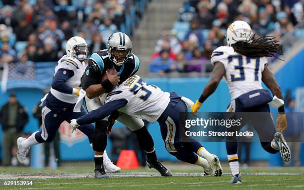 Jatavis Brown of the San Diego Chargers tackles Cam Newton of the Carolina Panthers during their game at Bank of America Stadium on December 11, 2016...