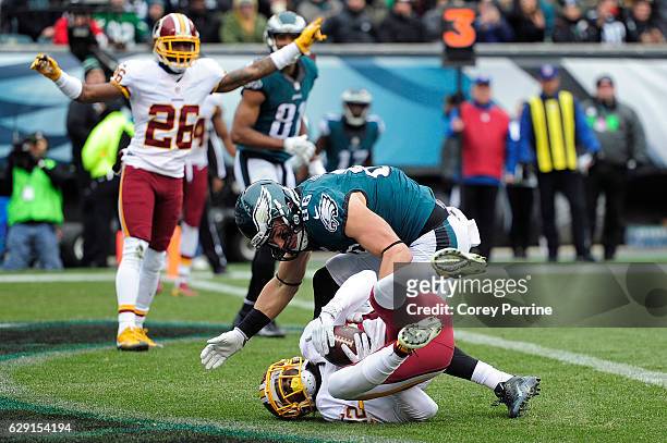 Deshazor Everett of the Washington Redskins catches an interception as Zach Ertz of the Philadelphia Eagles can't make the stop and Bashaud Breeland...