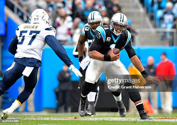 Cam Newton of the Carolina Panthers runs the ball against Jatavis Brown of the San Diego Chargers in the 1st quarter during the game at Bank of...