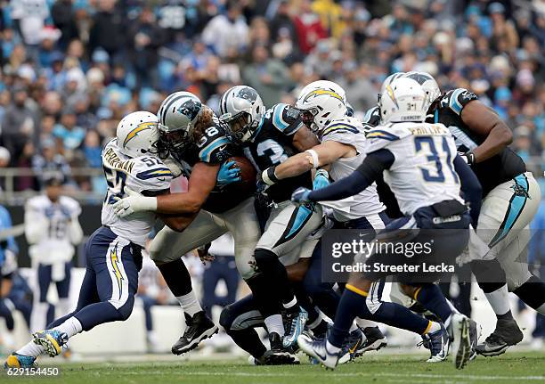 Fozzy Whittaker of the Carolina Panthers runs with the ball against the San Diego Chargers during their game at Bank of America Stadium on December...