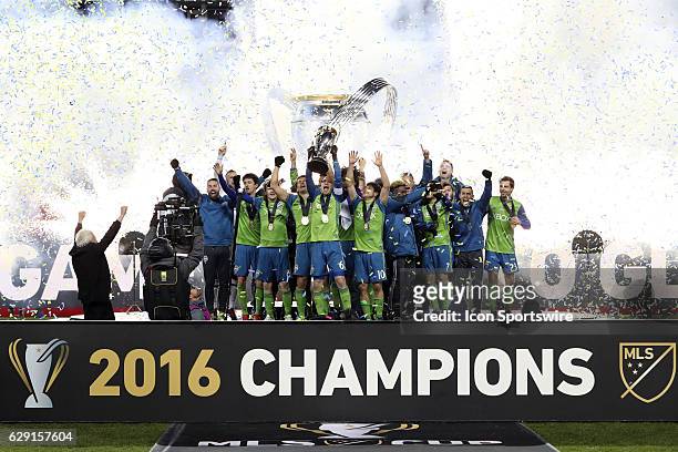Seattle captain Osvaldo Alonso holds the Philip F. Anschutz Trophy overhead while celebrating with his team. Toronto FC hosted Seattle Sounders FC in...