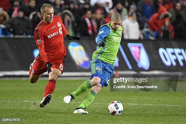 Toronto FC player Benoit Cheyrou chases Seattle Sounders Mid Fielder Osvaldo Alonso during the MLS Cup final game between the Seattle Sounders and...