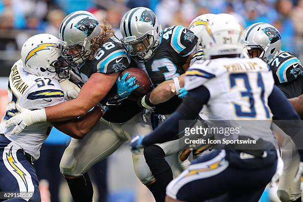 Carolina Panthers running back Fozzy Whittaker follows a block by guard Andrew Norwell during the second quarter between the Carolina Panthers and...