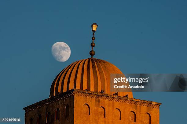 Moon is seen above the dome of the Great Mosque of Kairouan, also known as the Mosque of Uqba, during the celebrations for Mawlid al-Nabi, the birth...