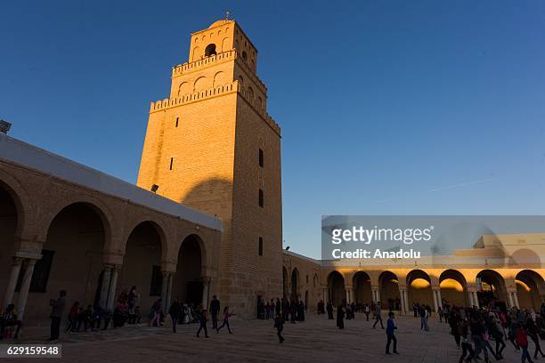 Muslims on their way to the Great Mosque of Kairouan, also known as the Mosque of Uqba, to attend the celebrations for Mawlid al-Nabi, the birth...