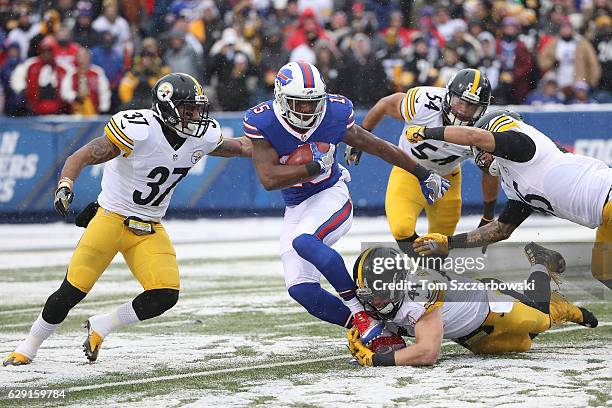 Brandon Tate of the Buffalo Bills is tackled by Tyler Matakevich of the Pittsburgh Steelers and Jordan Dangerfield of the Pittsburgh Steelers during...