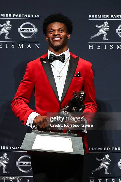 Heisman Trophy winner University of Louisville quarterback Lamar Jackson holds the Heisman Trophy after winning the 81st Annual Heisman Trophy press...