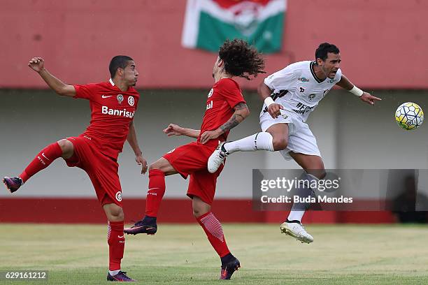 Of Henrique Dourado Fluminense struggles for the ball with Valdvia and William of Internacional during a match between Fluminense and Internacional...