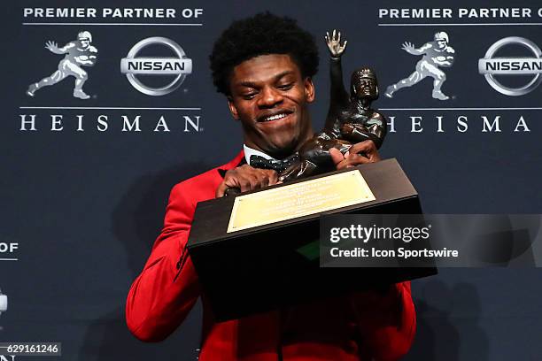 Heisman Trophy winner University of Louisville quarterback Lamar Jackson holds the Heisman Trophy after winning the 81st Annual Heisman Trophy press...