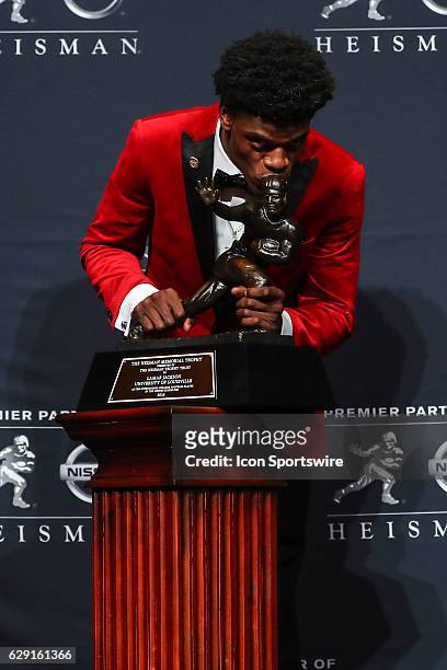 Heisman Trophy winner University of Louisville quarterback Lamar Jackson kisses the Heisman Trophy after winning the 81st Annual Heisman Trophy press...