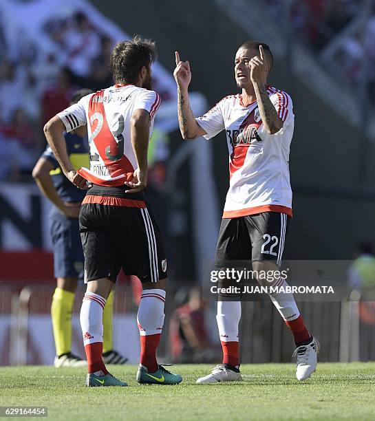 River Plate's midfielder Andres D'Alessandro talks to teammate midfielder Leonardo Ponzio during their Argentine first division football match...