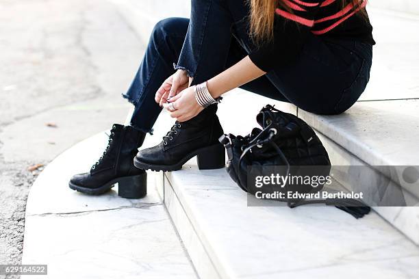 Sofya Benzakour, fashion and life style blogger @lacouleurdumoment, is wearing River Island shoes, Ikks blue denim jeans, an Ikks black bag, a black...