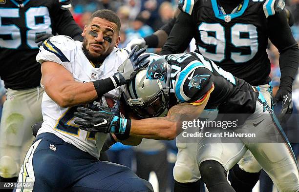 Kenneth Farrow of the San Diego Chargers loses his helmet and keeps running against Kurt Coleman of the Carolina Panthers in the 3rd quarter during...