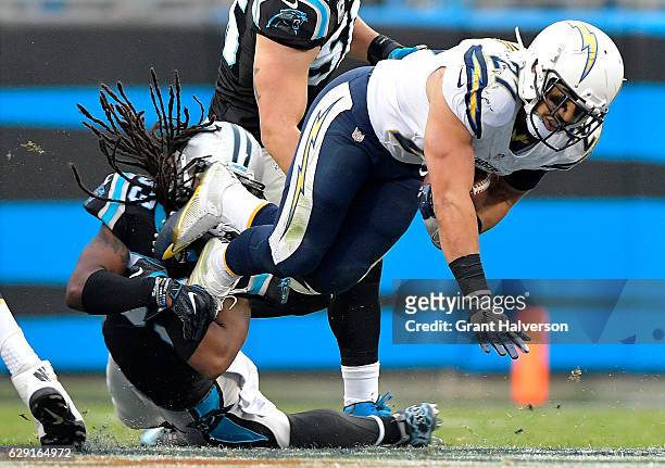 Kenneth Farrow of the San Diego Chargers runs the ball against Tre Boston of the Carolina Panthers in the 3rd quarter during the game at Bank of...