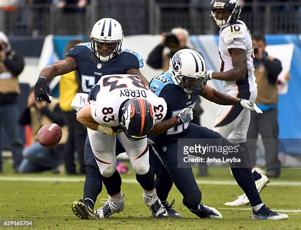 Tennessee Titans free safety Rashad Johnson puts a big hit on Denver Broncos tight end A.J. Derby to force a fumble after his catch late in the...