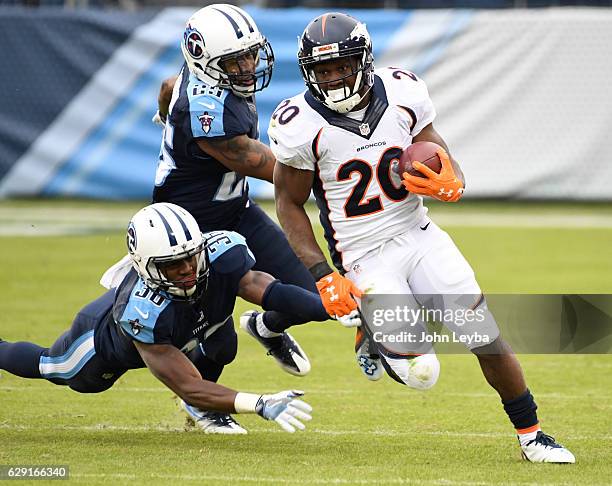 Denver Broncos running back Justin Forsett turns the corner on Tennessee Titans cornerback LeShaun Sims and Tennessee Titans free safety Rashad...