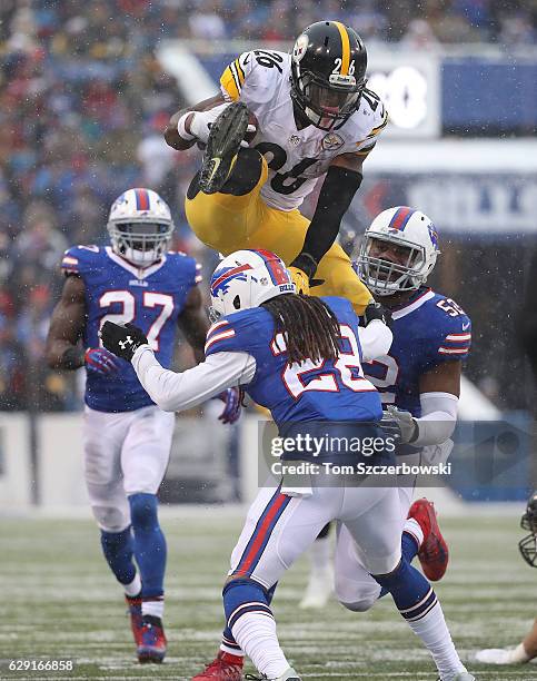 Le'Veon Bell of the Pittsburgh Steelers jumps over Ronald Darby of the Buffalo Bills during the second half at New Era Field on December 11, 2016 in...
